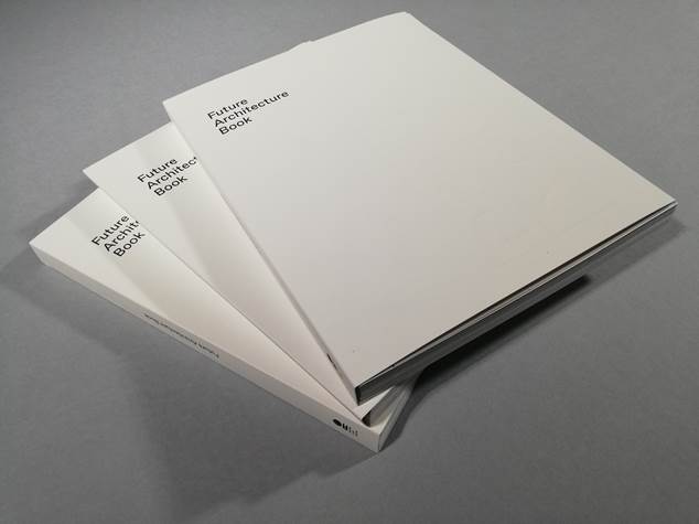 Three books displayed on a table. Blank cover with a black typeface for it title